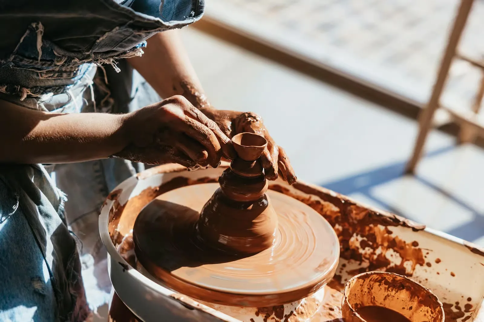 Traditional Moroccan ceramic pottery being shaped on a wheel